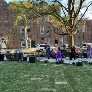 Band playing outside at their grand opening.