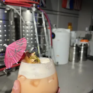 a hand holding a cocktail