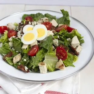 Romaine, tomatoes, grilled chicken breast, hard-boiled egg, bacon, blue cheese and scallions with French vinaigrette