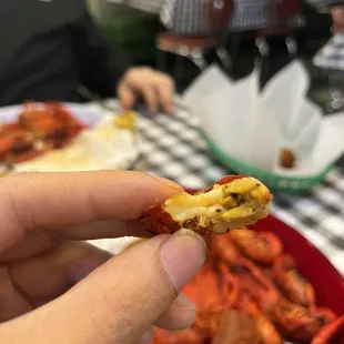 a person holding a piece of food