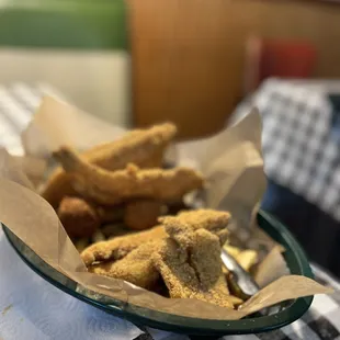 a basket of fried fish sticks