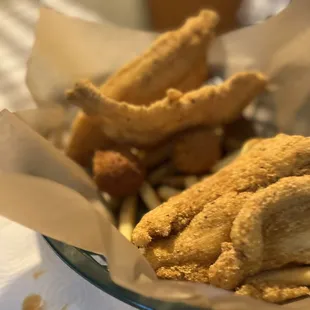 a basket of fried fish and fries