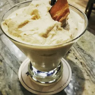 Kailua and bailey&apos;s Irish cream with creme de banana with dark creme de cacao and peanut butter with a candied bacon garnish