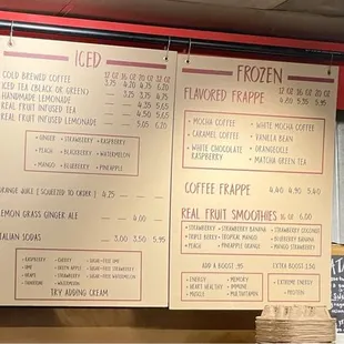 Menu board shows hot, iced and frozen drinks on the cream colored background, breakfast taco and oatmeal options on the blackboards.