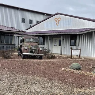 an old truck parked in front of a building