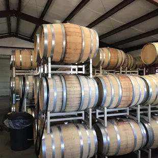 Inside the building, barrels of wine waiting to be bottled