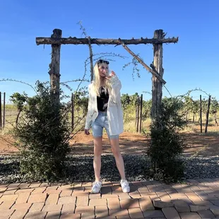 a woman standing in front of a gate
