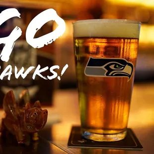 a pint of beer and a go hawks pint