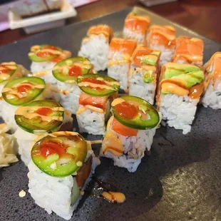 a plate of sushi with a variety of toppings