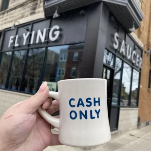 a person holding a coffee mug