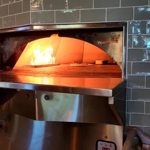 Fire oven grill baking pizza