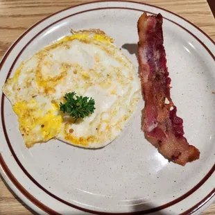 ... Accompanied by eggs over hard and bacon