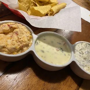 Tortilla Chips and Trio of Pimento Cheese, Queso, Artichoke Dip.