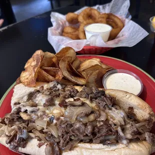 a steak sandwich and onion rings