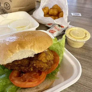 Original chicken sandwich with overpriced tater tots in the back