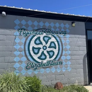 Flywheel mural on building
