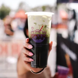 a woman holding up a cup