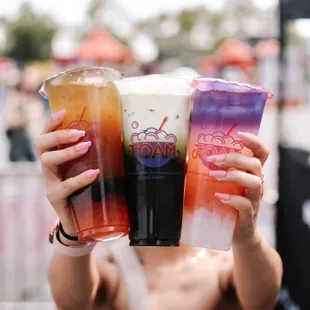 a woman holding two drinks