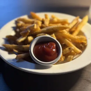 a plate of french fries and ketchup