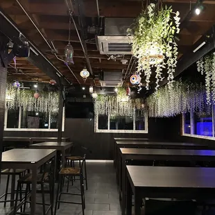 tables, chairs, and hanging plants
