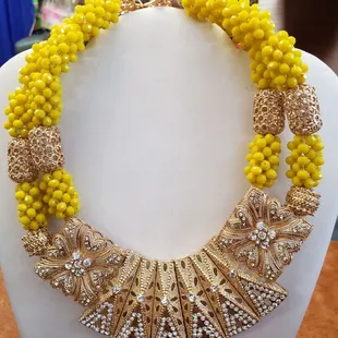ows a necklace made of yellow beads