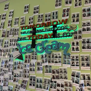 a wall full of photos of people