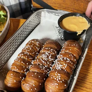 a tray of doughnuts and a bowl of salad