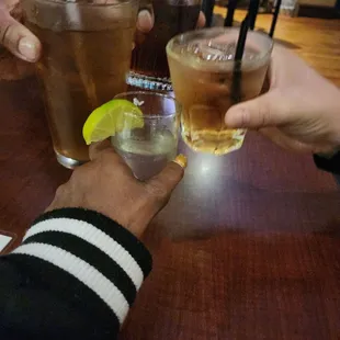 two people toasting with drinks