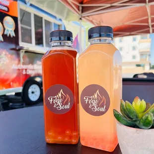 two bottles of liquid on a table