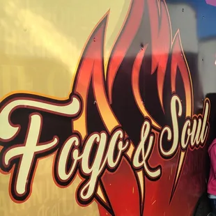 a woman leaning against a food truck