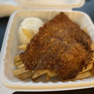 fried chicken and fries in a styrofoam container
