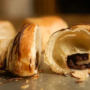 a croissant pastry with a bite taken out of it