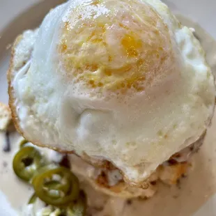 a fried egg on a toasted bun with jalapenos