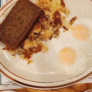 a breakfast of eggs, hash browns and toast