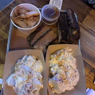 Three meat plate with potato salad