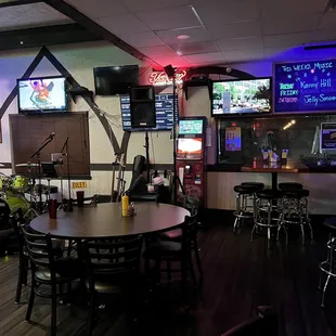 a woman standing in front of the bar