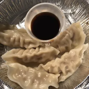 a plate of dumplings and sauce