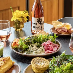 a table of food and a bottle of wine