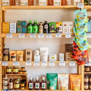 a shelf of honeys, teas, and condiments