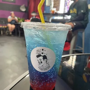 a blue drink with a yellow straw