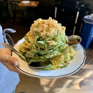 Homemade Caesar salad stacked to the heavens