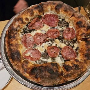 The Mushroom pizza combination that also includes garlic and some special cheeses. We add Soppressata meat to it. No tomato sauce needed.