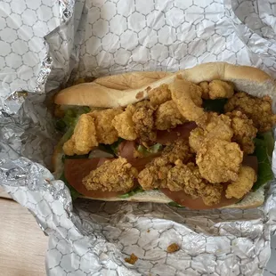 a chicken sandwich wrapped in foil