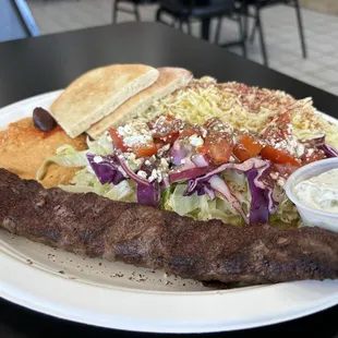 Ground beef and lamb kabobs plate with spicy hummus