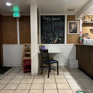 a restaurant with a chalkboard on the wall