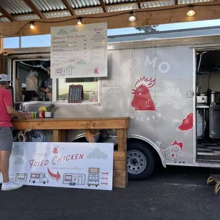 a man standing in front of a food truck
