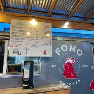 a food truck with a menu on the side