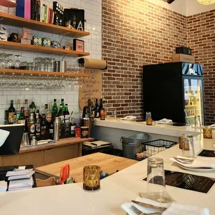 a kitchen with a brick wall and a bar