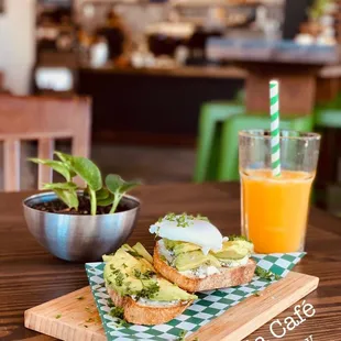 a plate of food and a glass of orange juice