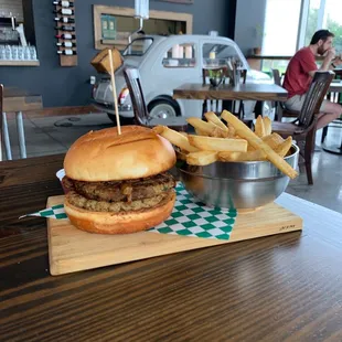 a burger and fries on a cutting board
